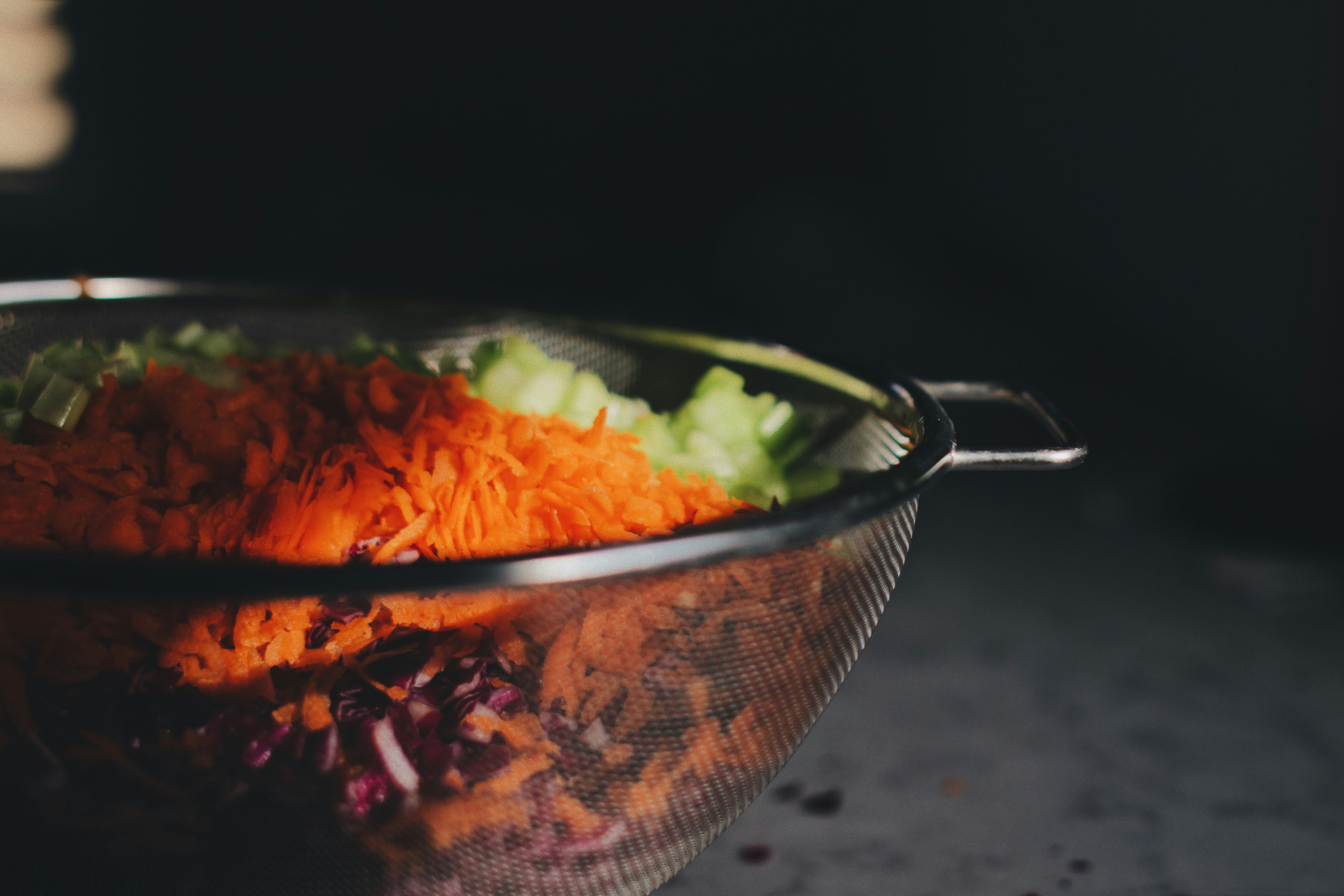 chopped vegetables on gray steel strainer